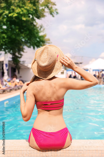 Young woman near pool on sunny day