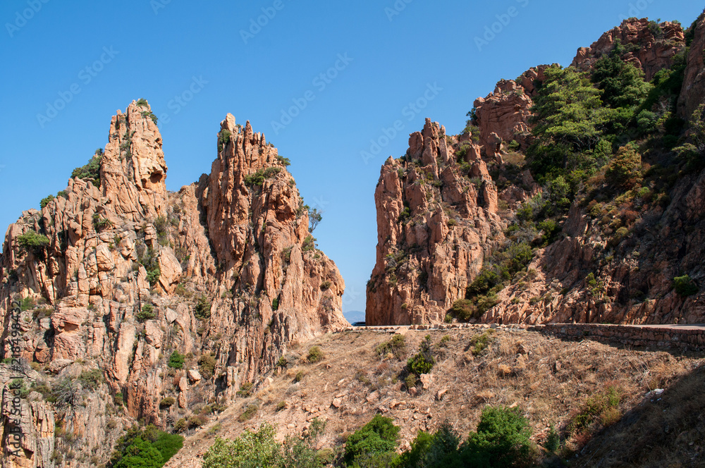 Fototapeta premium A road in the middle between two rocks on the island of Corsica (region Calanche)
