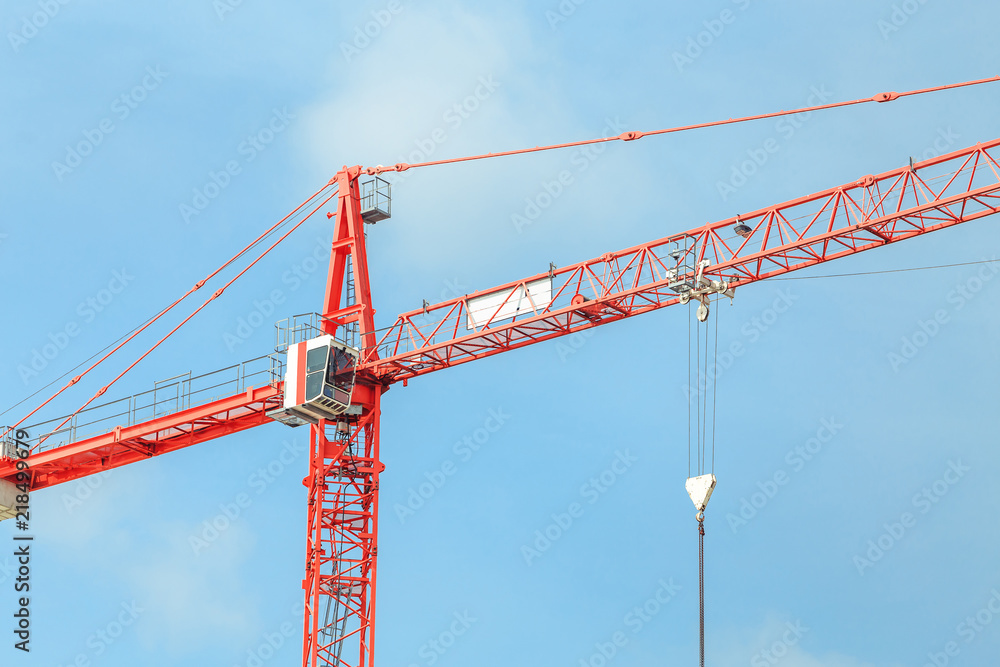 Construction tower cranes against blue sky background Construction tower cranes against blue sky background