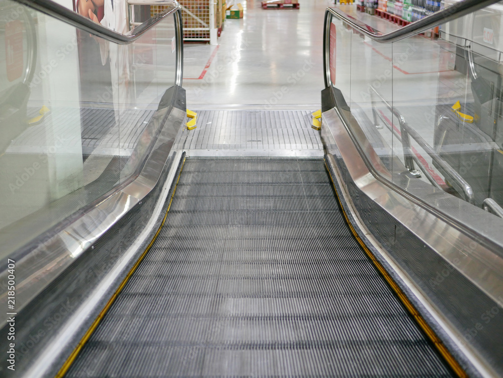 Close up of a moving shopping trolley escalator's steps that is about