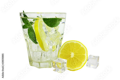 glass of soda water with ice cubes, lemon and mint