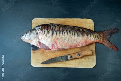 Delicious fresh fish (carp) on dark background for healthy food, diet or cooking concept