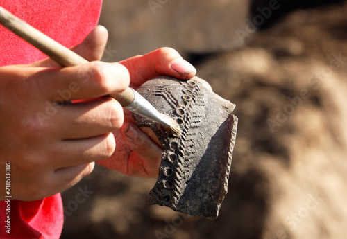 The find in the archaeological excavation is a piece of an ancient earthen vessel photo