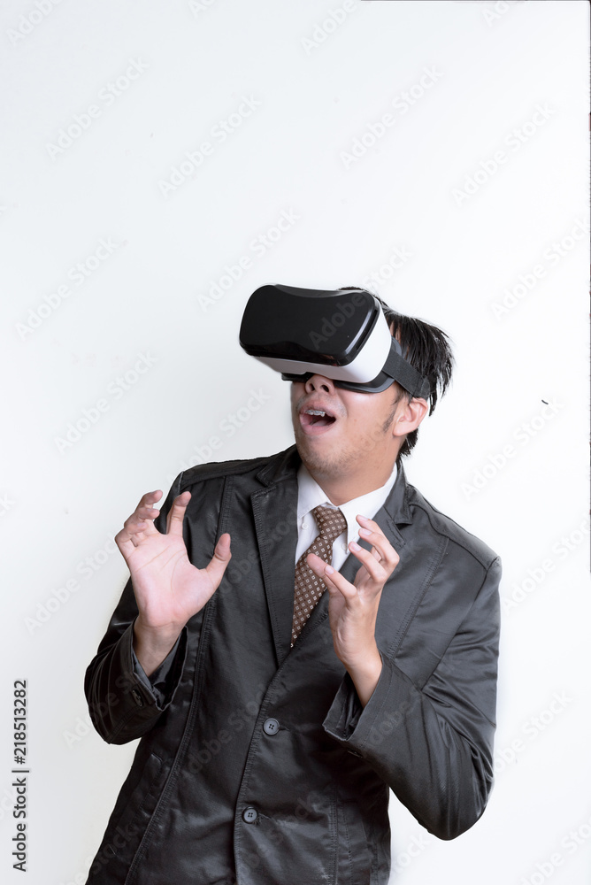 Asian Businessman wearing virtual reality on white background Asian Businessman wearing virtual reality on white background