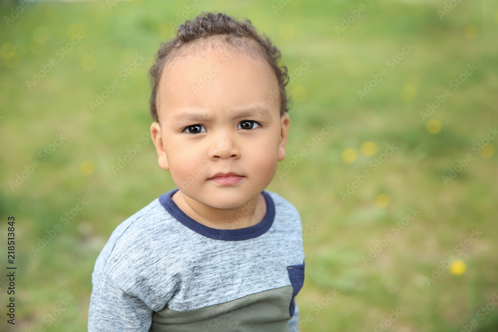 Cute African-American baby in stylish clothes posing outdoors Cute African-American baby in stylish clothes posing outdoors