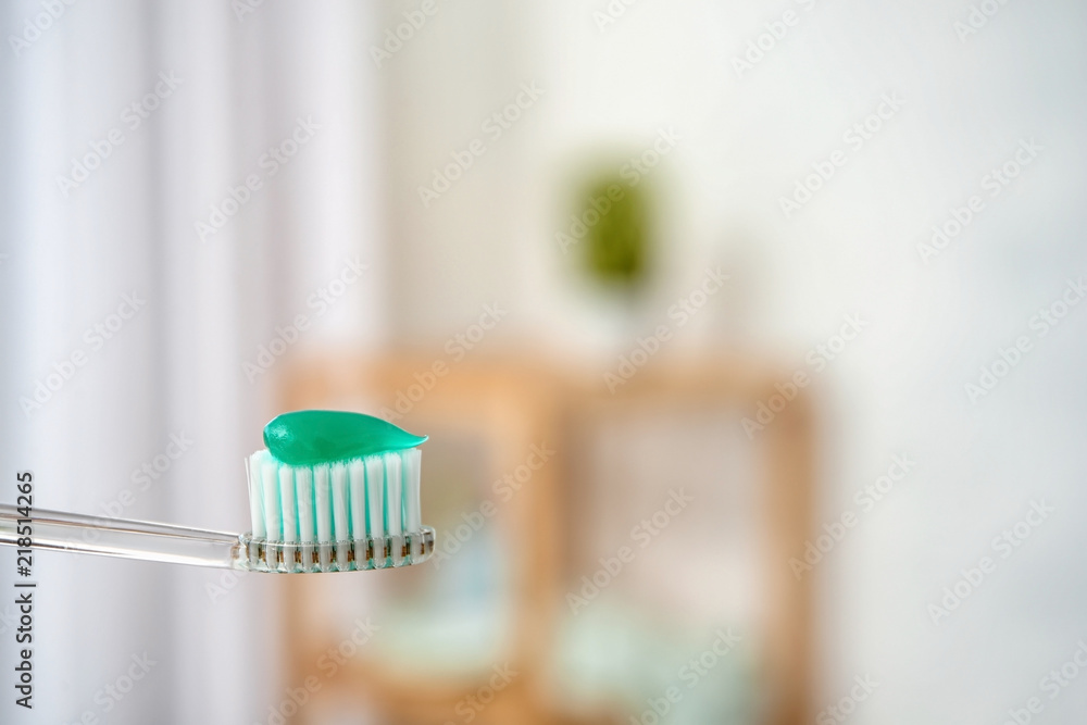 Toothbrush with paste on blurred background, closeup Toothbrush with paste on blurred background, closeup