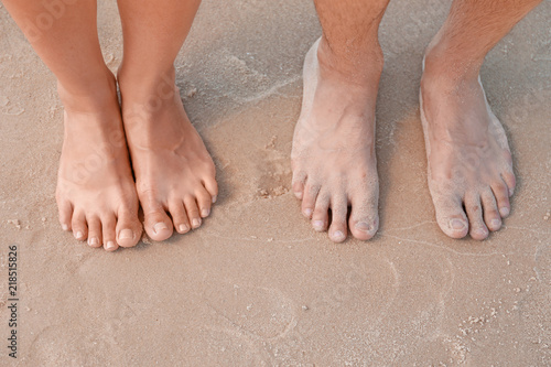 Happy young couple at beach on sunny day, closeup of feet © New Africa