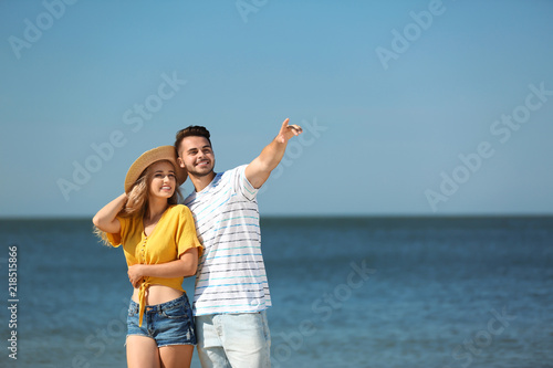 Happy young couple at beach on sunny day