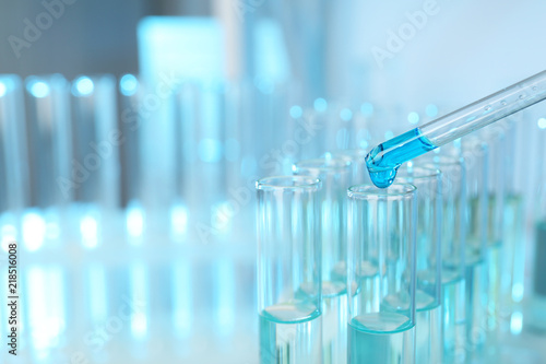 Dripping reagent into test tube with sample at laboratory, closeup. Chemical analysis