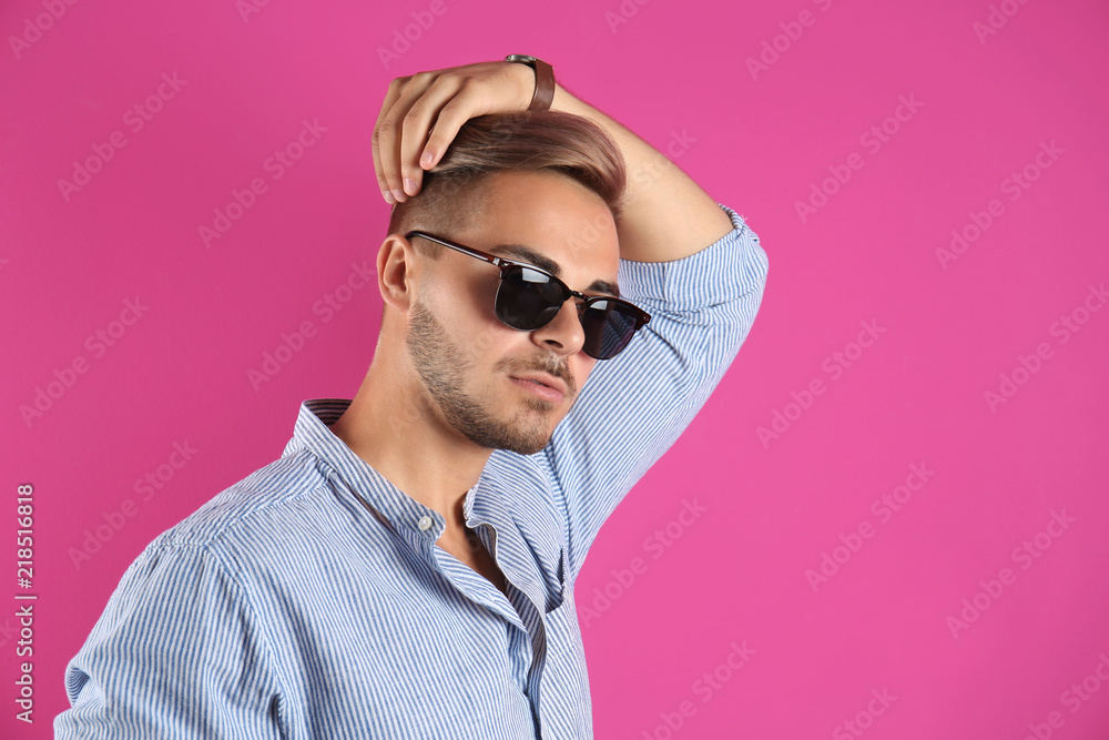 Young man with trendy hairstyle on color background Young man with trendy hairstyle on color background
