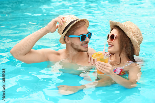 Young couple in pool on sunny day