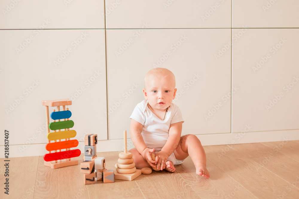 Cute little baby boy playing with stacking rings Cute little baby boy playing with stacking rings