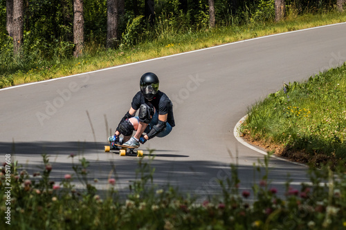 Longboard downhill rider make fast in a turn photo