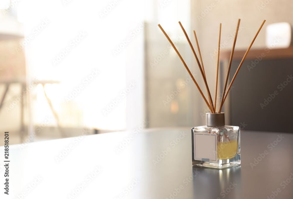 Reed air freshener on table in room - obrazy, fototapety, plakaty 