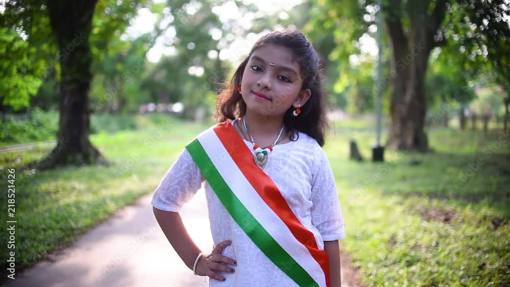 A little cute Indian girl wearing Indian National flag as accessories and posing and giving cute expressions, sunset, golden hour, Independence Day, Republic Day A little cute Indian girl wearing Indian National flag as accessories and posing and giving cute expressions, sunset, golden hour, Independence Day, Republic Day