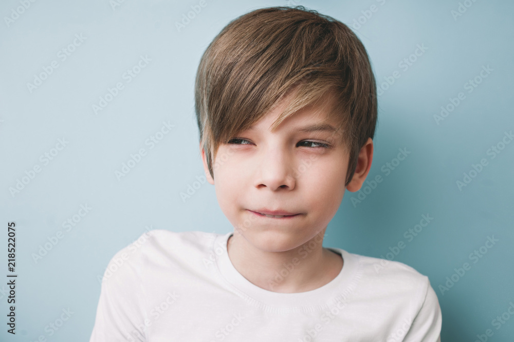 Thoughtful boy with bitter prank bitten his lower lip with his teeth and narrowed his eyes Thoughtful boy with bitter prank bitten his lower lip with his teeth and narrowed his eyes