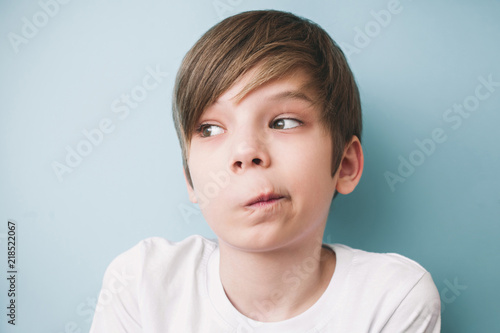 Canvas Print Surprised boy twisted his mouth in grimace of perplexity