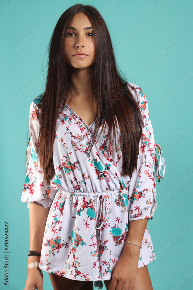 Young fashionable woman in jumpsuit. Studio shoot on blue background Young fashionable woman in jumpsuit. Studio shoot on blue background
