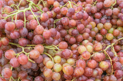 Red grapes grown locally for sale at farmer's market on summer morning in natural light