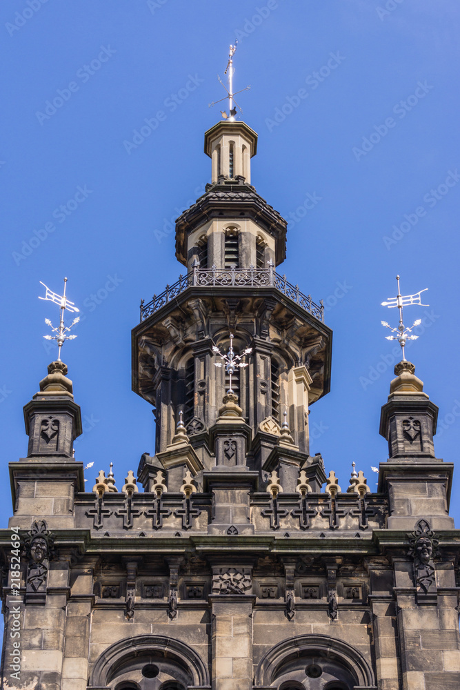 Edinburgh, Scotland, UK - June 13, 2012: Tower of Augustine United Church against blue sky. Dark brown stones in Dutch style.