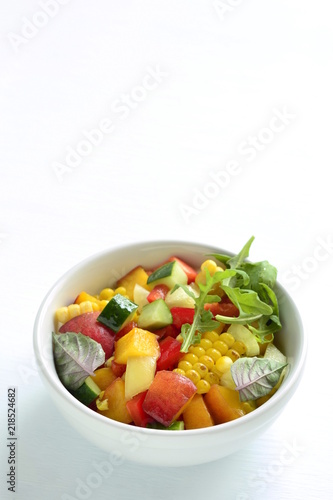 Salad with sweet corn, cucumber, sweet pepper and peach