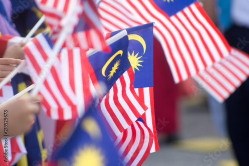 Canvas Print Hand waving Malaysia flag also known as Jalur Gemilang in conjunction with the Independence Day celebration or Merdeka Day