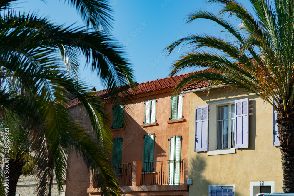 Colors of Provence, France, summertime in small city on Mediterranean Sea, colorful facades and windows and palm trees