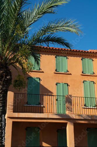Colors of Provence, France, summertime in small city on Mediterranean Sea, colorful facades and windows and palm trees