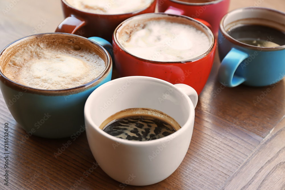 Cups of fresh aromatic coffee on wooden table Cups of fresh aromatic coffee on wooden table