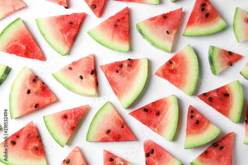 Flat lay composition with slices of watermelon on white background