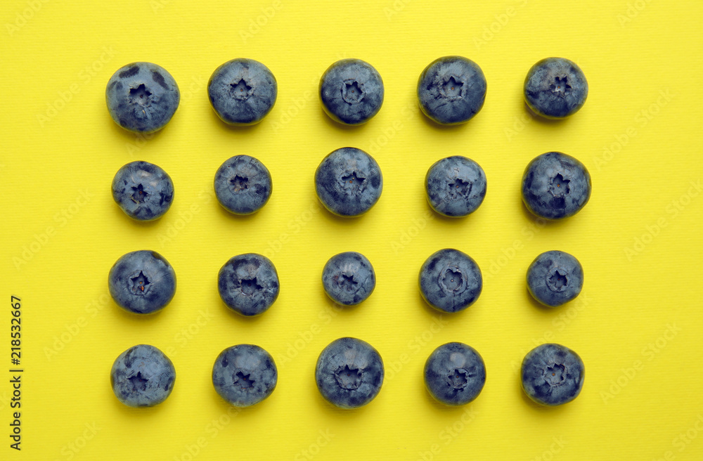 Flat lay composition with tasty blueberry on color background Flat lay composition with tasty blueberry on color background