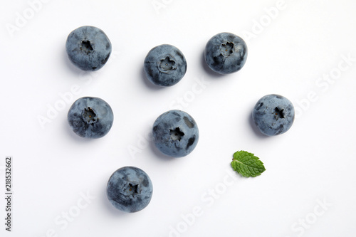 Flat lay composition with tasty blueberry on white background
