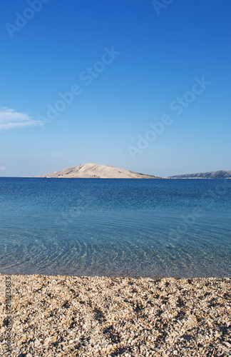 Croazia: l'acqua cristallina di Rucica, la spiaggia di ciottoli in una baia brulla circondata da un paesaggio desertico a sudest del villaggio di Metajna, sull'isola di Pago photo