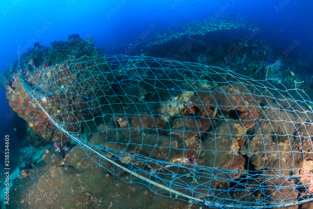 A huge abandoned ghost fishing net entangled over a large part of