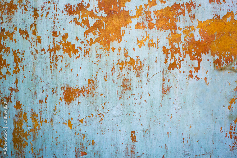 Old blue dirty painting grunge urban wall background with rusty stains