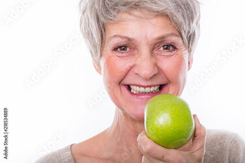 beautiful mature healthy woman with apple
