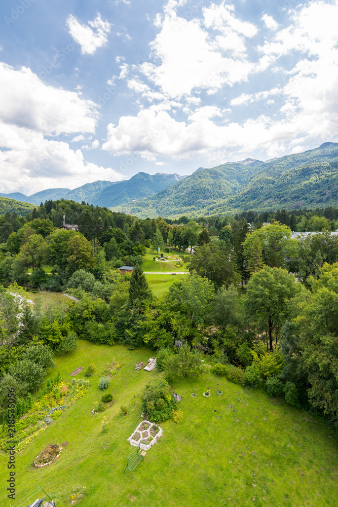 Landscape of Slovenia mountains in Triglav national park. Look from the church tower near Bohinj lake. Small garden near church