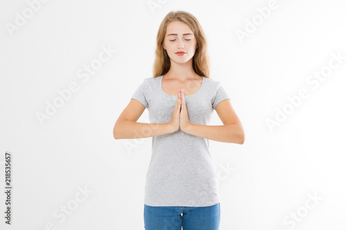 Close-up of hands of pretty woman, girl in t-shirt , meditating indoors, focus on arms in Namaste gesture. Asian medicine, yoga concept. Mock up. Copy space. Template. Blank. © paulcannoby