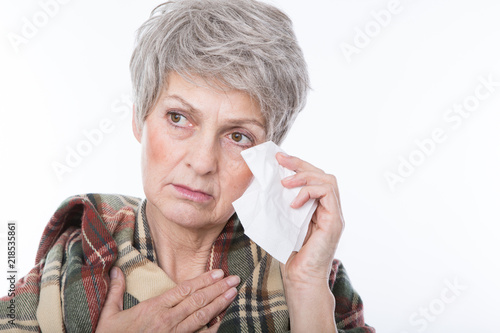  senior woman with gray hair has a flu