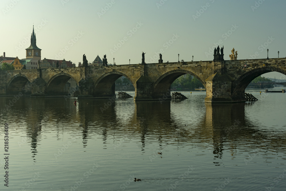 View of the panorama of the old historic center of Prague by the river and the Charles Bridge in the early morning