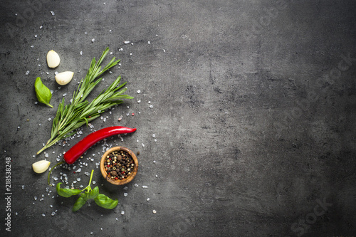 Fototapeta Naklejka Na Ścianę i Meble -  Selection of spices herbs and greens on black top view. 