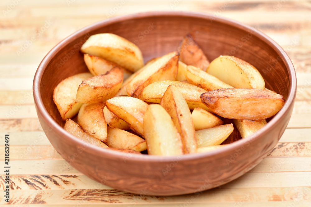 Fried potatoes in a plate. Junk food. Golden fries. Fried potatoes in a plate. Junk food. Golden fries.