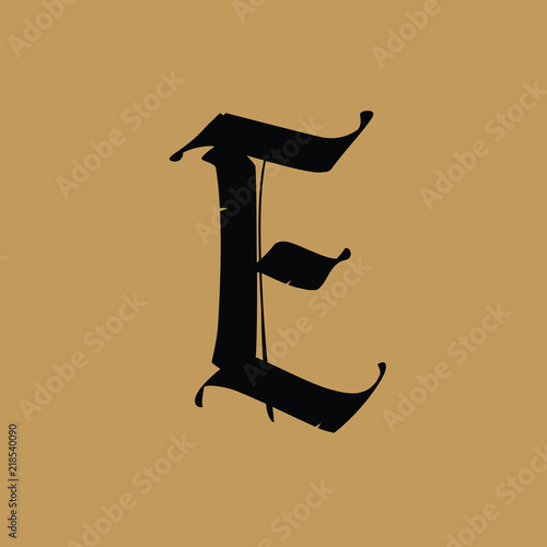 Letter E, in the Gothic style. Vector. Alphabet. The symbol is isolated on a golden background. Calligraphy and lettering. Medieval Latin letter. Logo for the company. Monogram. Elegant font for tatto