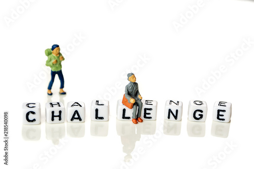 White cubes with word challenge on white background with miniature figurines