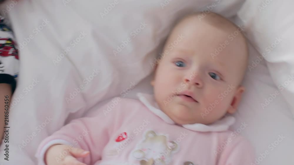Laughing elder brother and cute baby sister lying on bed together. Lovely siblings Laughing elder brother and cute baby sister lying on bed together. Lovely siblings