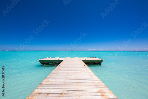 wooden Pier blue sky on background and caribbean sea