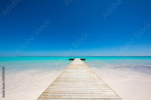wooden Pier in azure water blue clear sky on carribean islands in Dominican Republic Punta Cana