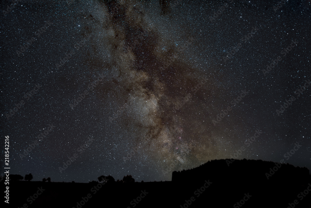 Center of Milky Way standing upright above silhouette of hills