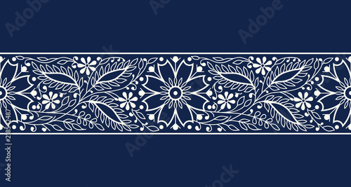Woodblock printed indigo dye seamless ethnic floral border. Traditional oriental ornament of India, elegant flowers and leaves, ecru on navy blue background. Textile design.