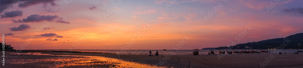 panorma - beautiful orange purple sunrise at beach shore of thailand
